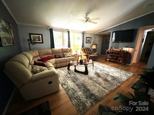 living room featuring ceiling fan, lofted ceiling, wood-type flooring, crown molding, and a textured ceiling