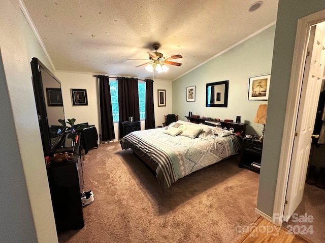 bedroom with light carpet, ceiling fan, a textured ceiling, and lofted ceiling