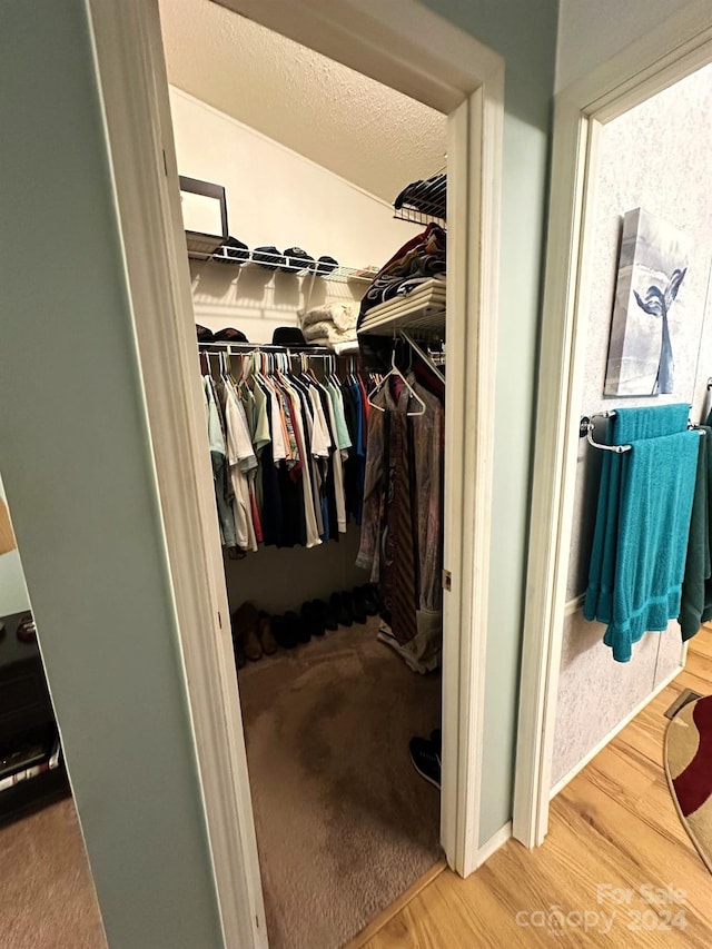 walk in closet with hardwood / wood-style floors