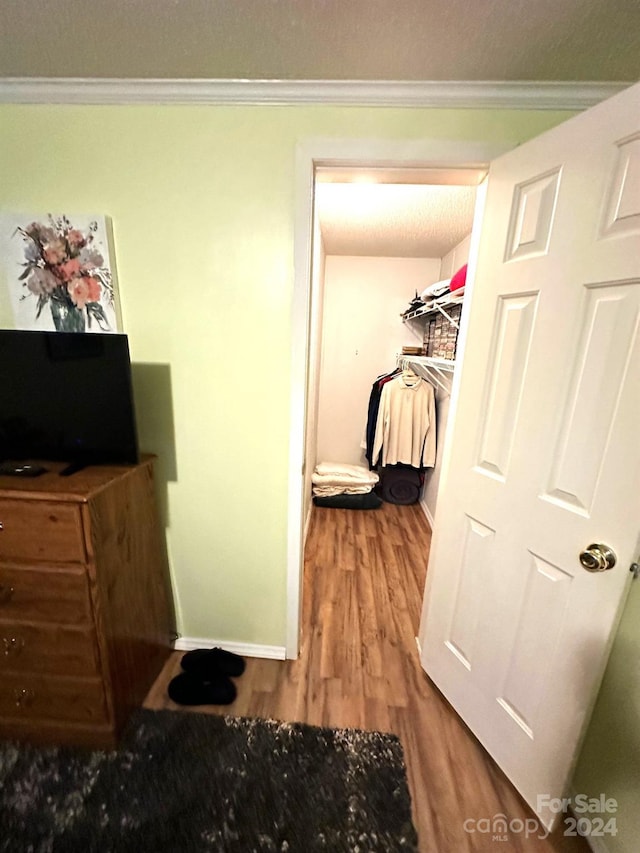 interior space featuring ornamental molding and hardwood / wood-style floors