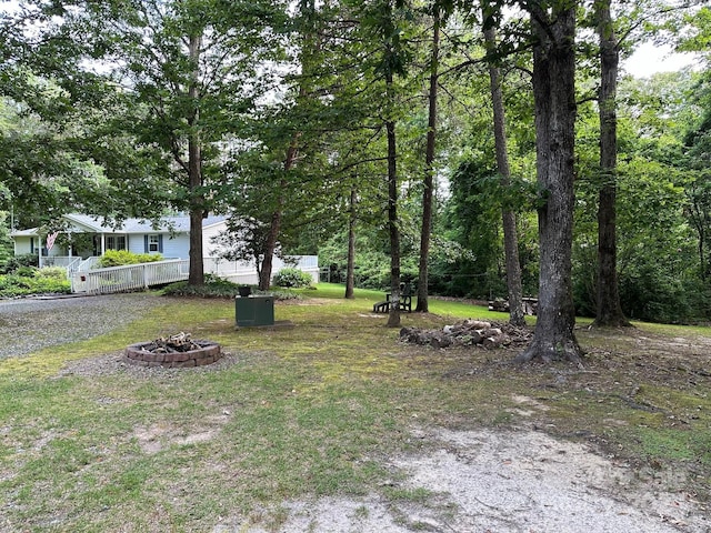 view of yard with a fire pit