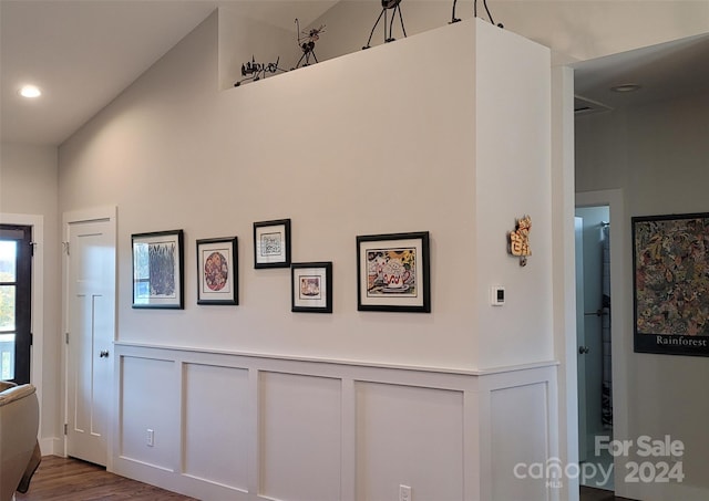 interior space with hardwood / wood-style flooring and high vaulted ceiling