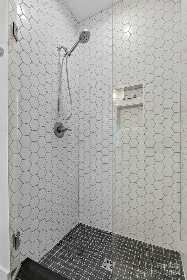 bathroom with tiled shower