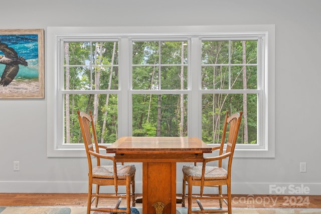 dining area with hardwood / wood-style flooring and a healthy amount of sunlight