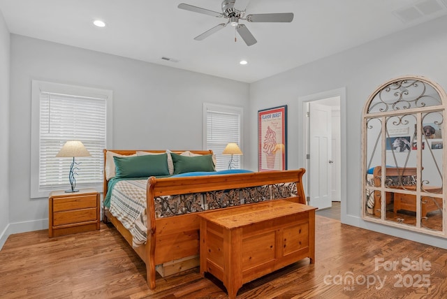 bedroom with visible vents, baseboards, recessed lighting, and wood finished floors