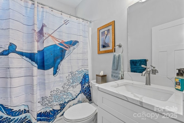 full bathroom with curtained shower, vanity, and toilet