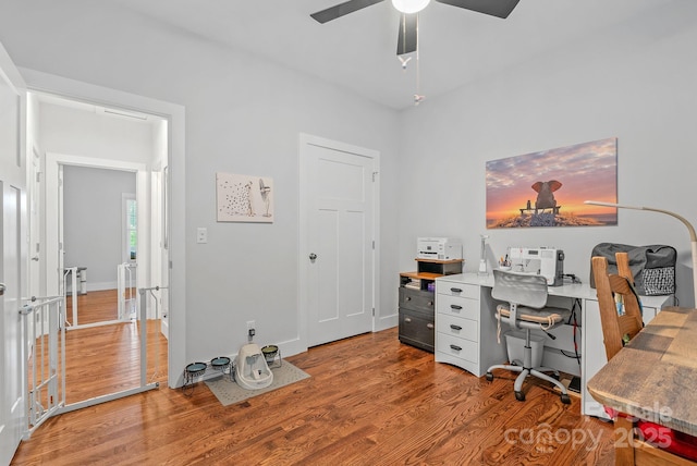 home office with a ceiling fan and wood finished floors