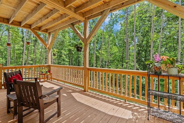 wooden deck with a wooded view