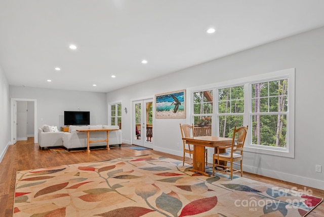 dining space with wood finished floors, baseboards, and recessed lighting