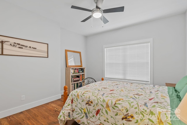bedroom featuring wood finished floors, baseboards, and a ceiling fan