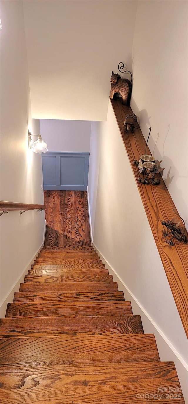 stairs with baseboards and wood finished floors