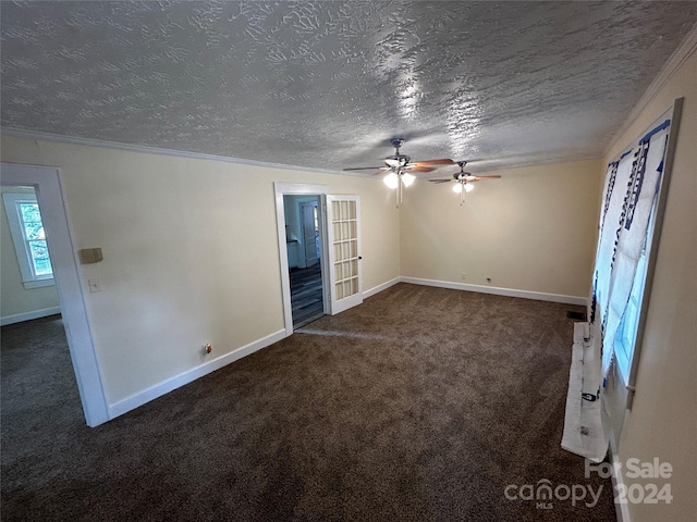 interior space with ornamental molding, a textured ceiling, dark colored carpet, and ceiling fan