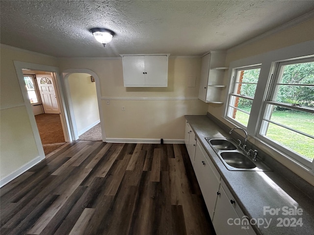 kitchen featuring sink, white cabinetry, dark hardwood / wood-style floors, and a textured ceiling