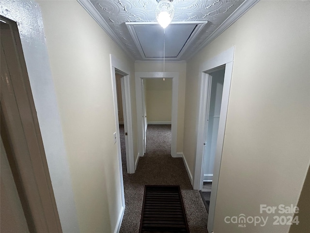 hallway featuring ornamental molding and carpet