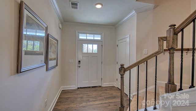 entryway with dark wood-type flooring, ornamental molding, and plenty of natural light