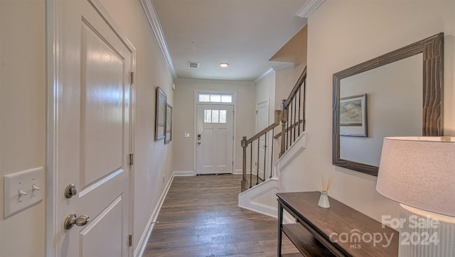 foyer entrance featuring crown molding and dark wood-type flooring