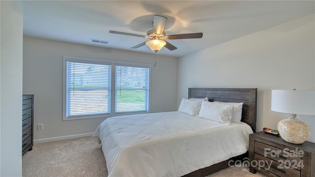 bedroom featuring light carpet and ceiling fan