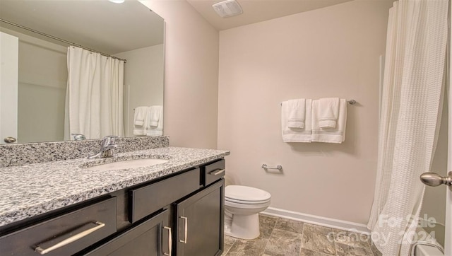 bathroom featuring vanity, tile patterned flooring, and toilet