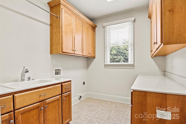 clothes washing area with washer hookup, cabinet space, a sink, electric dryer hookup, and baseboards