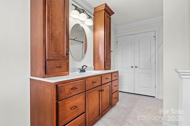 bathroom with crown molding and vanity