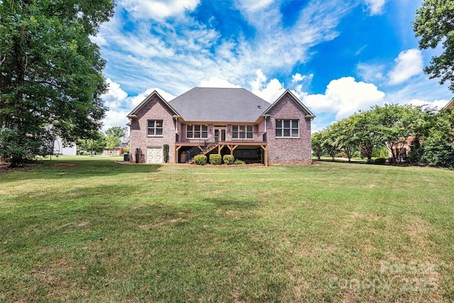 rear view of property featuring brick siding, a yard, stairway, and a wooden deck