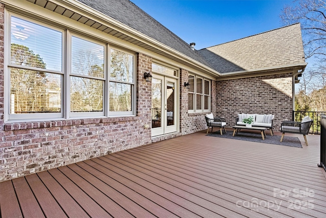 wooden terrace featuring french doors and an outdoor living space