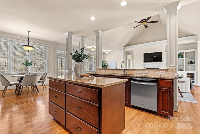 kitchen featuring ornate columns, dishwasher, a sink, and decorative light fixtures