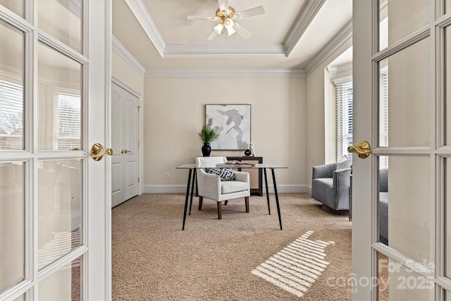 office space featuring ornamental molding, a raised ceiling, and light colored carpet