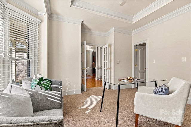 interior space featuring ceiling fan, baseboards, french doors, ornamental molding, and a raised ceiling