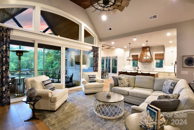 living room featuring visible vents, a ceiling fan, wood finished floors, high vaulted ceiling, and recessed lighting