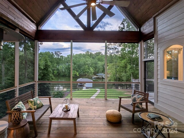 sunroom featuring ceiling fan, wooden ceiling, and lofted ceiling