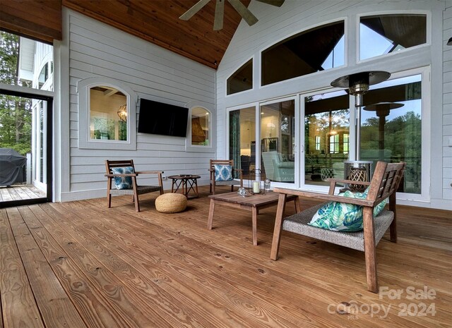 wooden terrace with ceiling fan and area for grilling