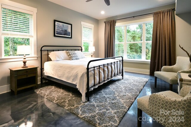 bedroom featuring a ceiling fan, recessed lighting, concrete flooring, and baseboards