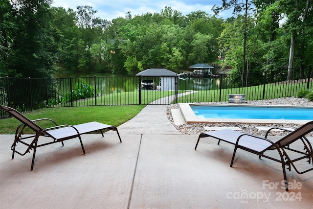 view of pool with a yard, a fenced backyard, a fenced in pool, and a gazebo