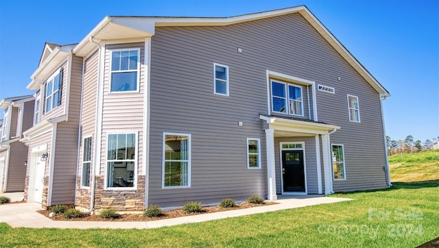 view of front facade with a garage and a front lawn