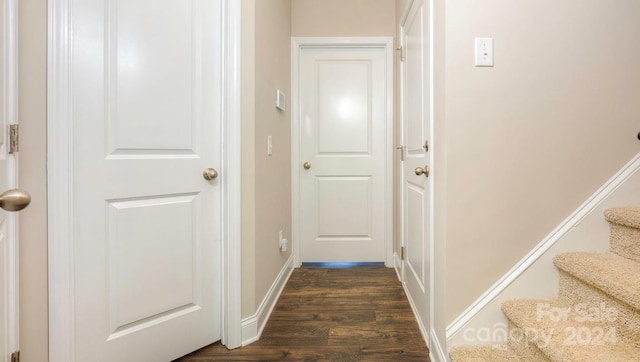 hall with dark wood-type flooring