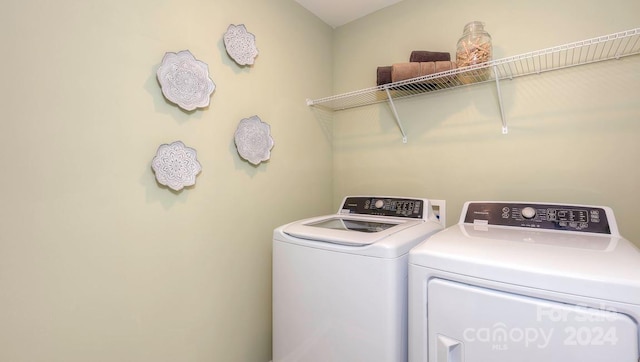 clothes washing area featuring washer and clothes dryer