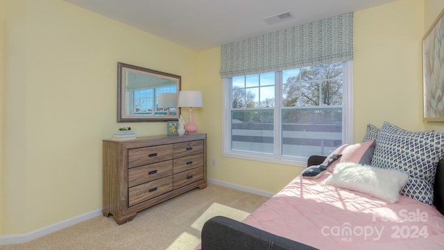 bedroom featuring light carpet