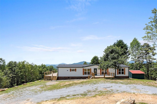 view of front of property featuring crawl space and a deck