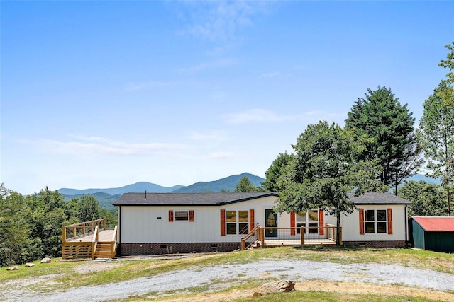 manufactured / mobile home with crawl space and a deck with mountain view