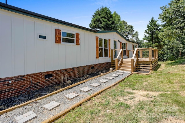 view of front facade with crawl space and a wooden deck