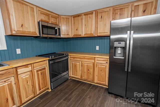 kitchen featuring stainless steel appliances and dark wood-style flooring