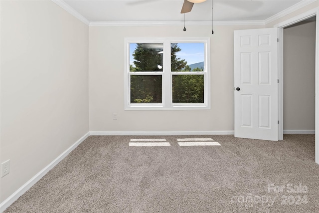 unfurnished bedroom featuring baseboards, carpet, a ceiling fan, and crown molding