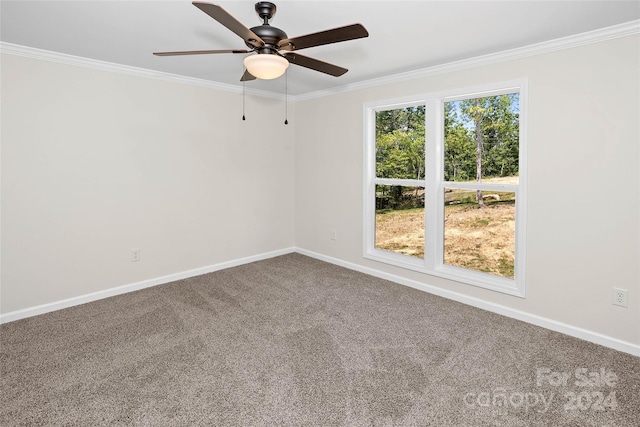 carpeted empty room with baseboards, ceiling fan, and crown molding