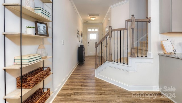 interior space with wood-type flooring and crown molding