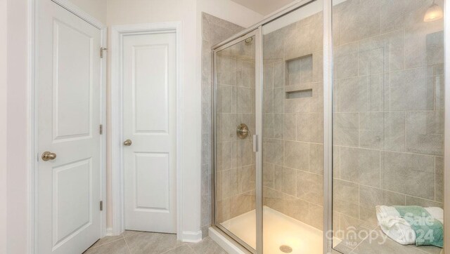 bathroom featuring tile patterned flooring and walk in shower