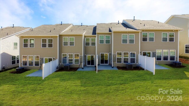 back of property with central AC, a yard, and a patio