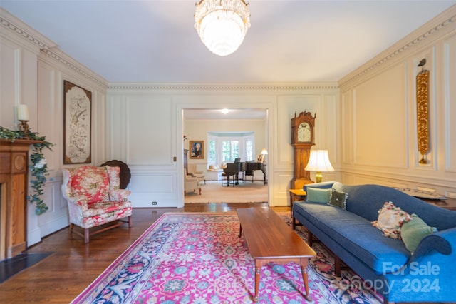 living room with dark hardwood / wood-style flooring and a notable chandelier