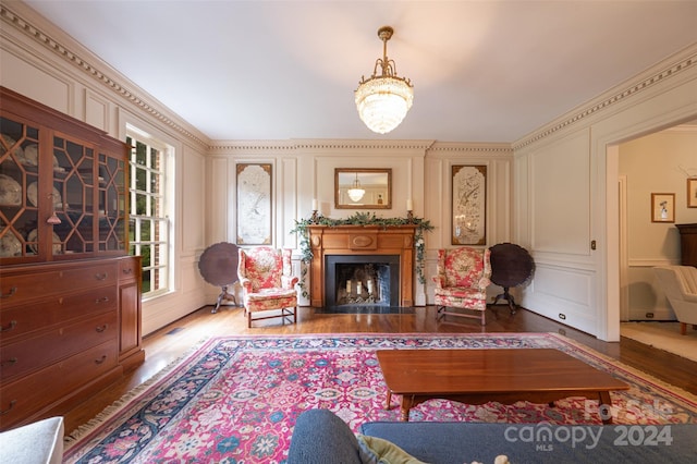 living room with crown molding and hardwood / wood-style flooring