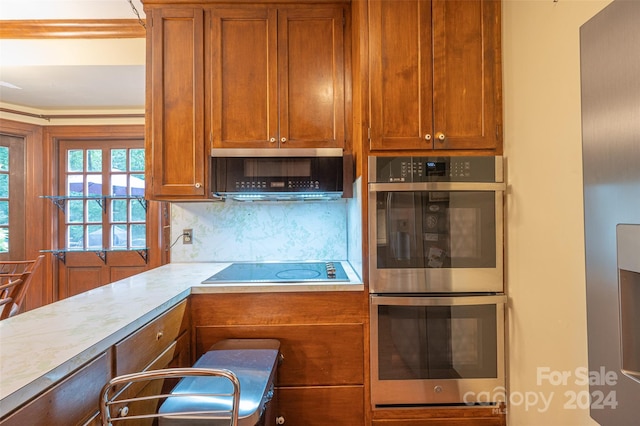 kitchen with stainless steel appliances and backsplash